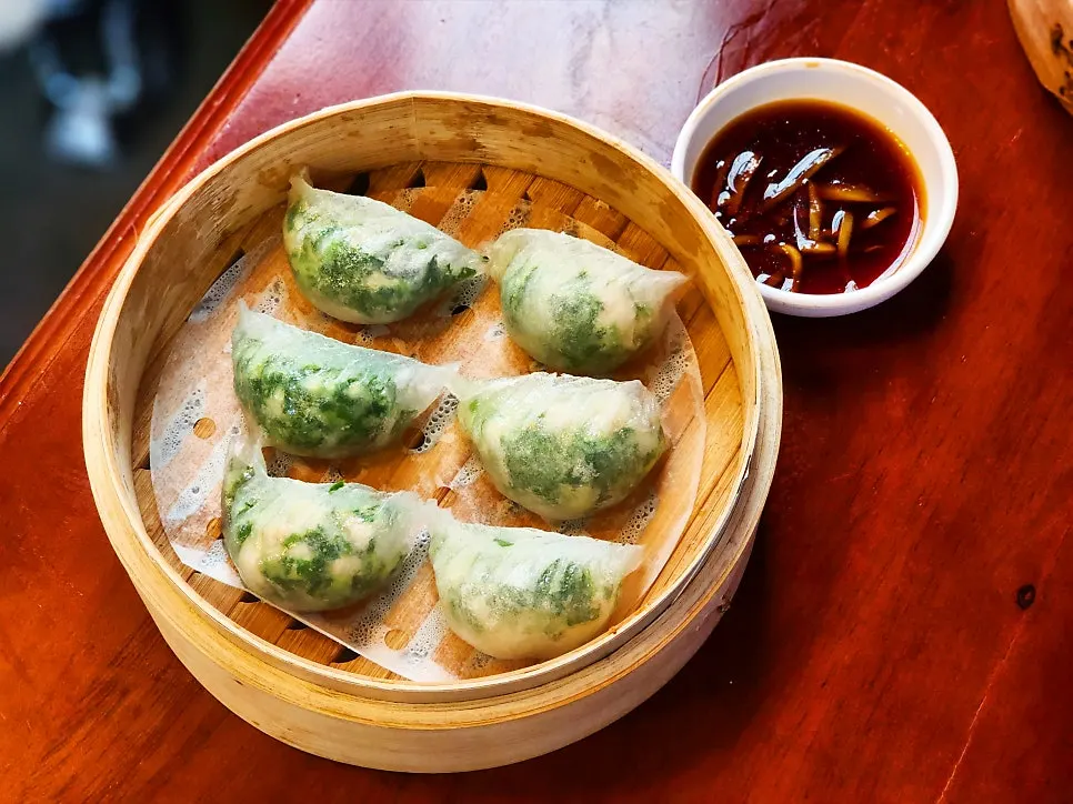 A steamer of crystal moon dumplings with translucent wrappers