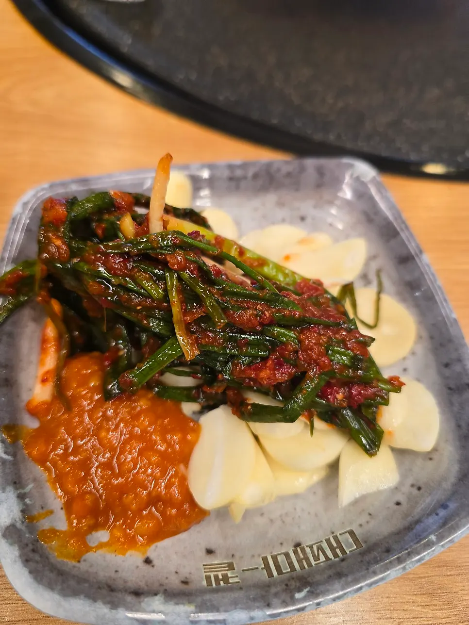 Daepae samgyeopsal paired with bracken fern and minari