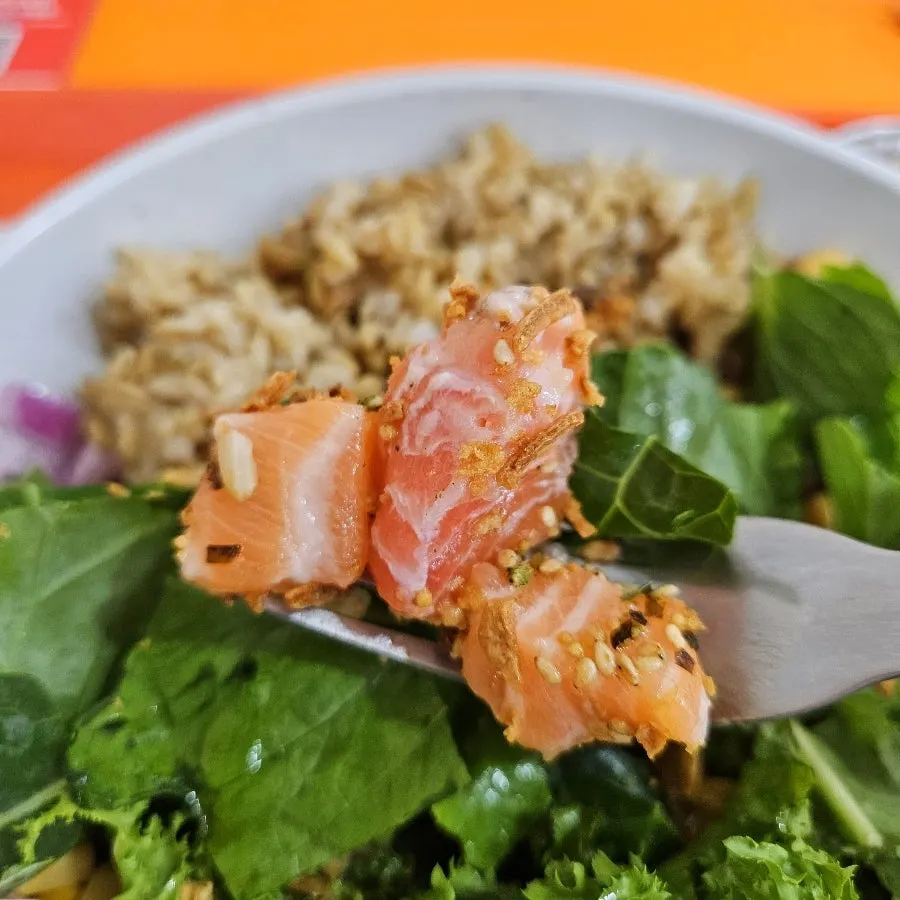 Close-up of salmon poke generously topped with salmon