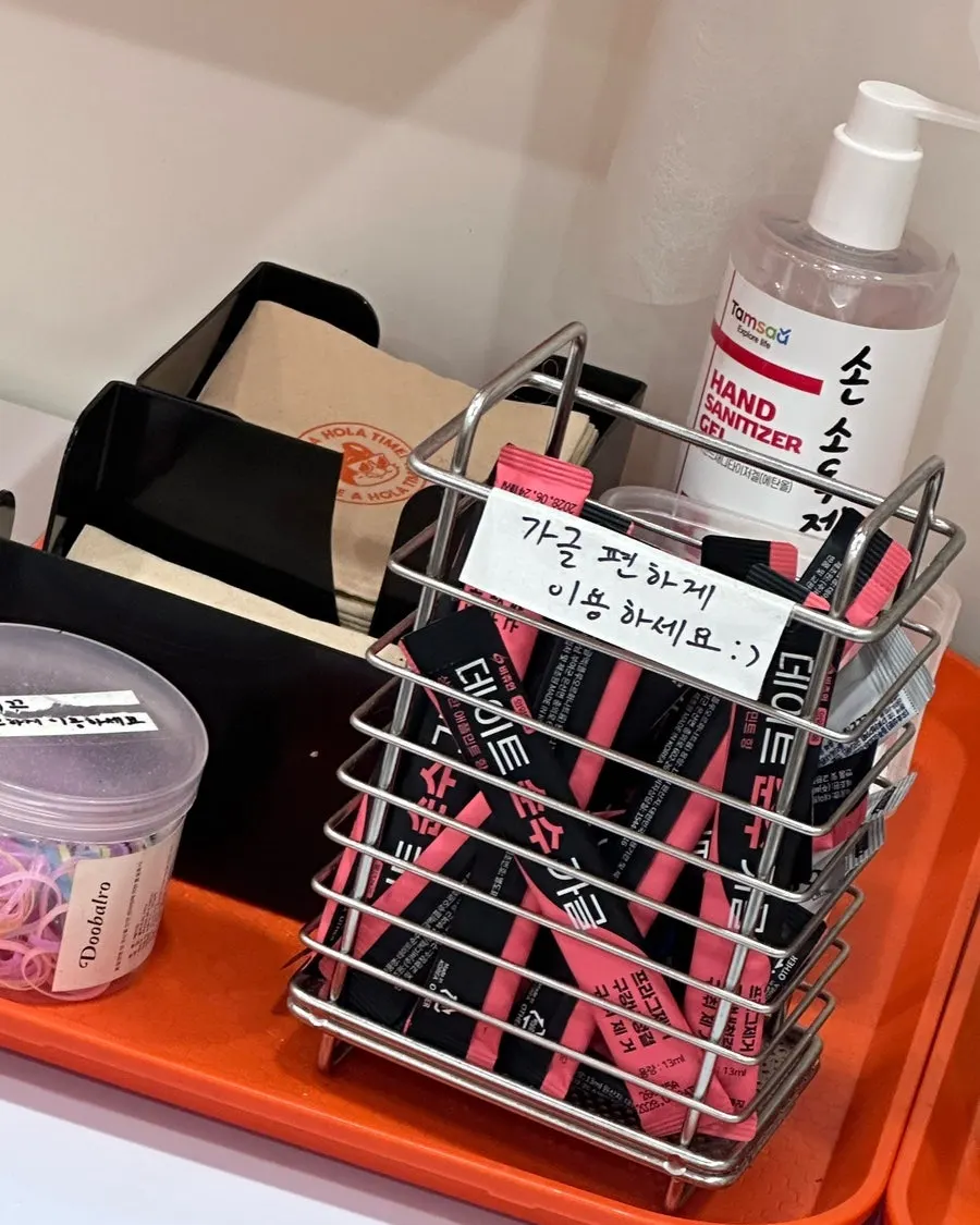 Mouthwash, hair ties, and tea set out in one corner of the restaurant