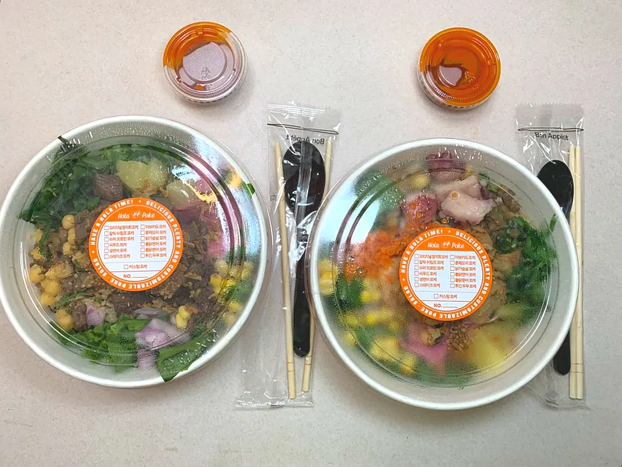 Neatly packed Ola Poke takeout containers