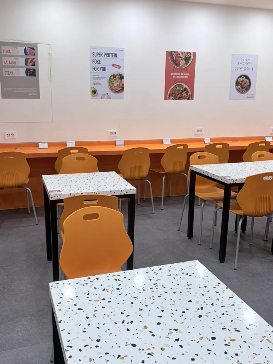 Interior of Ola Poke Gangnam with orange accent colors