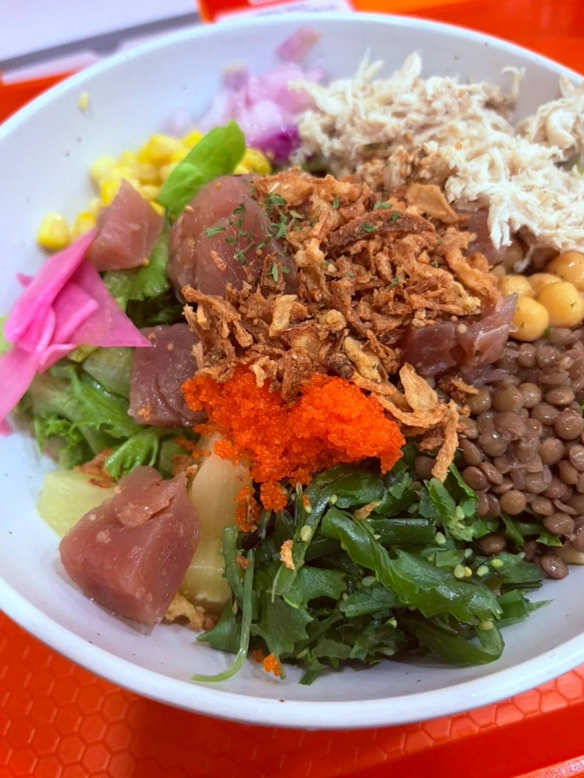 A bowl of tuna poke containing pineapple