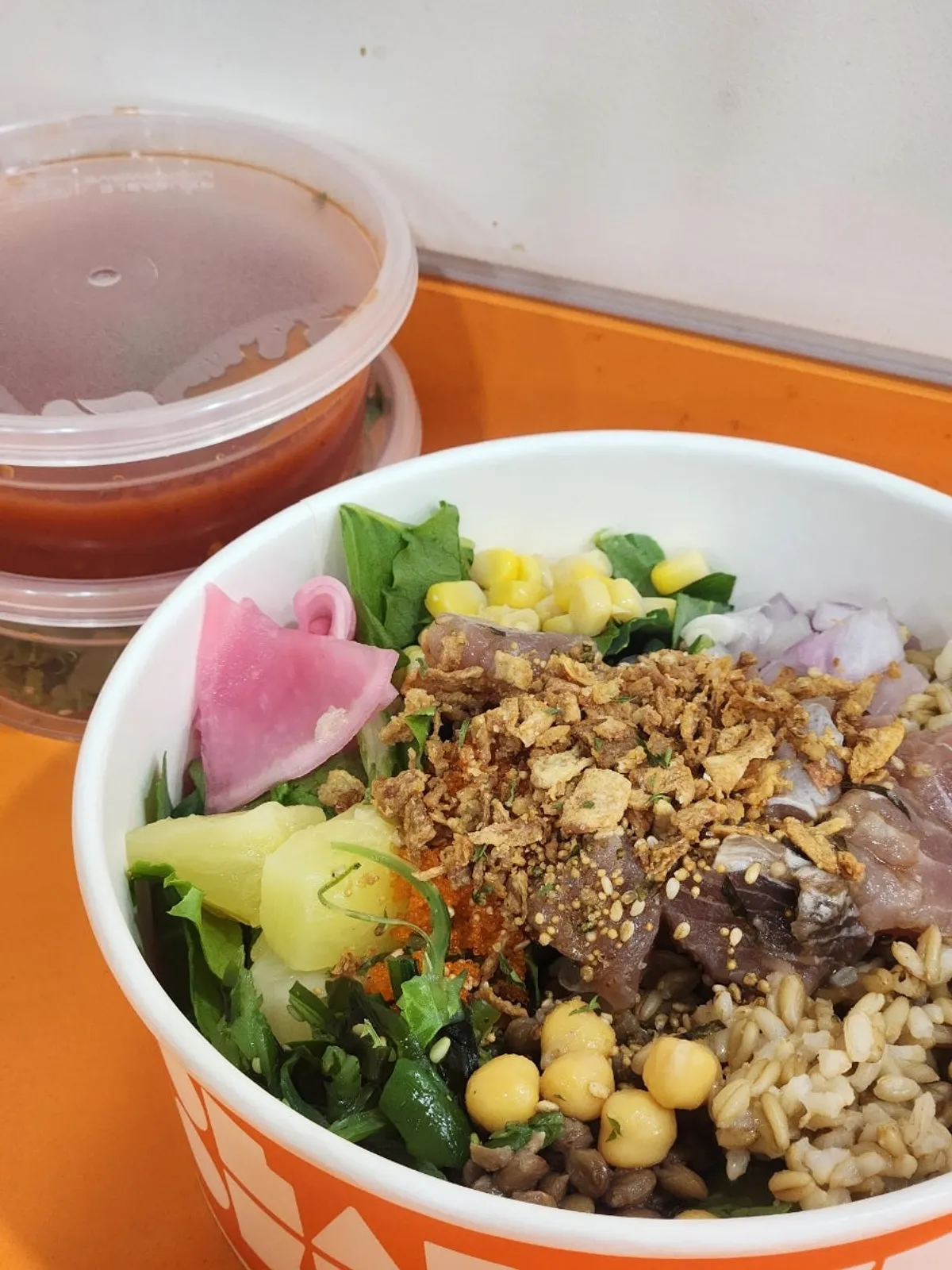 Tomato-based witch soup served alongside the poke