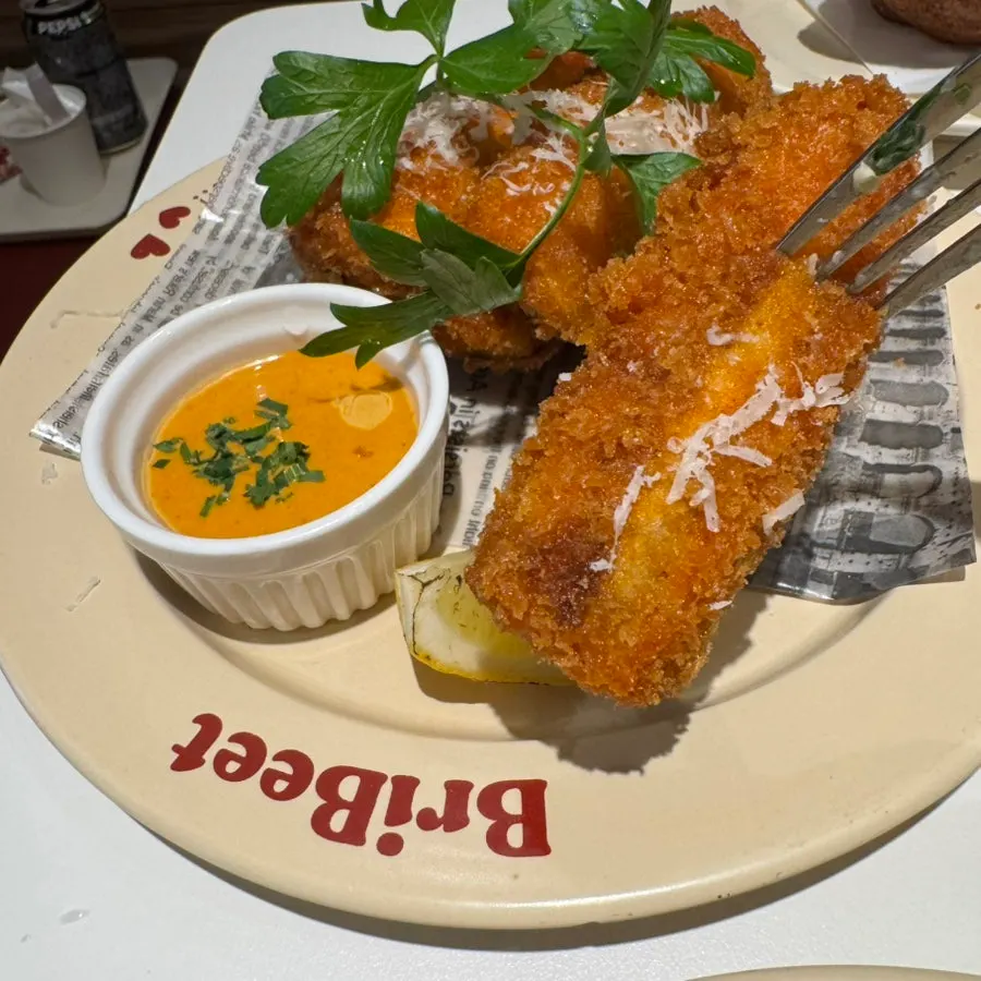 Close-up of eggplant fritters served with sauce
