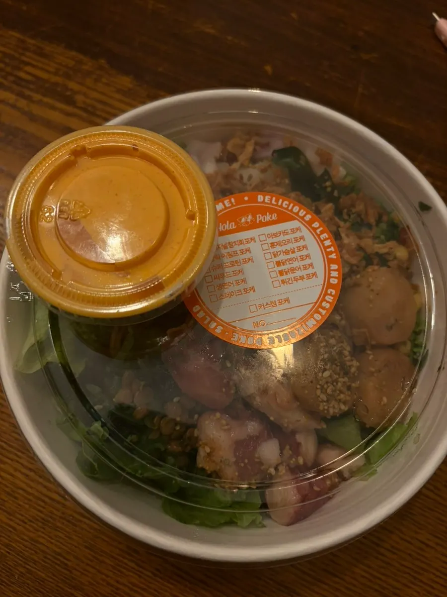 Takeout poke drizzled with sriracha mayo sauce