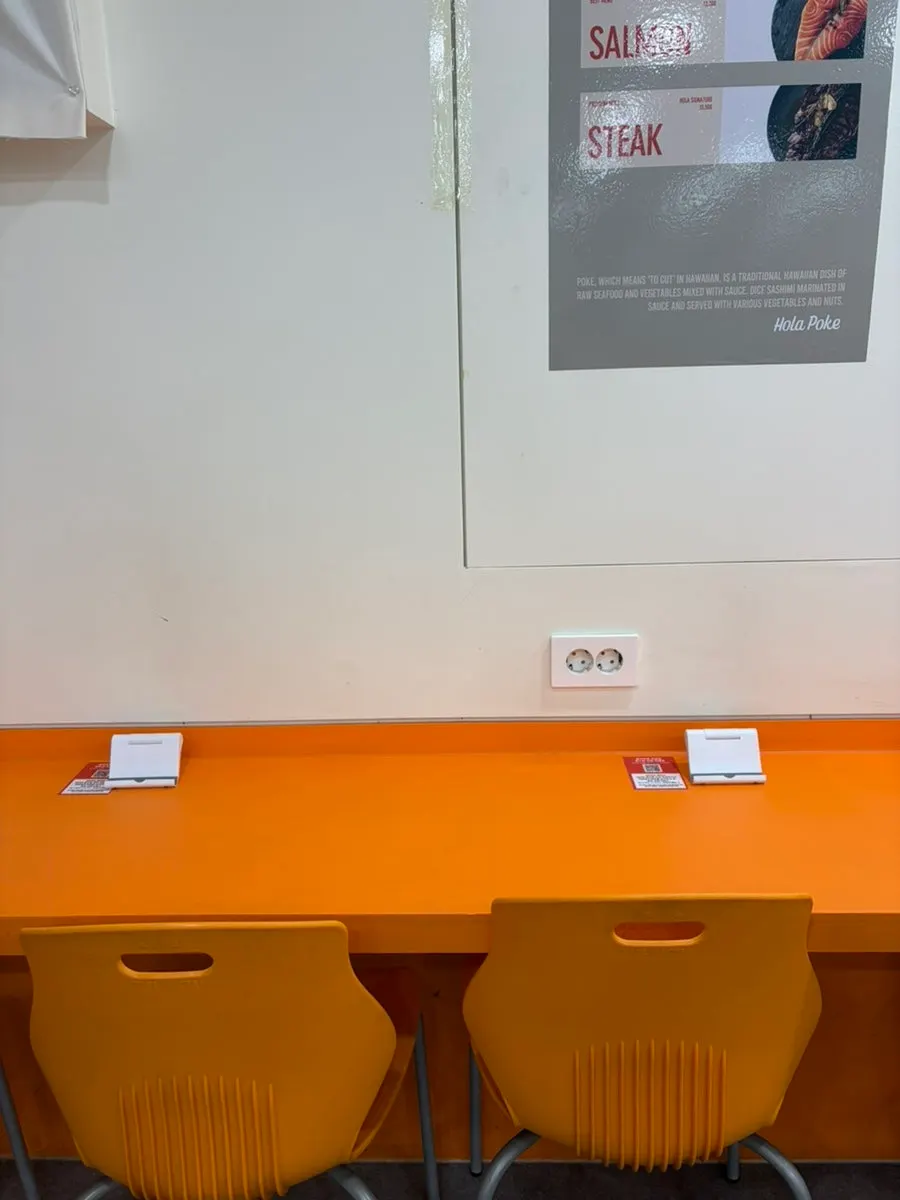 Solo-dining seat with phone stand and outlet