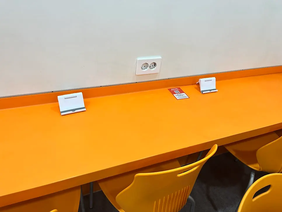 Solo seating with an outlet and phone stand