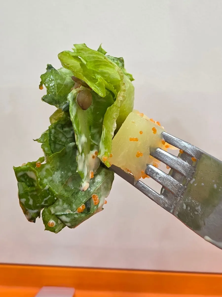 A spoonful of seafood poke lifted up