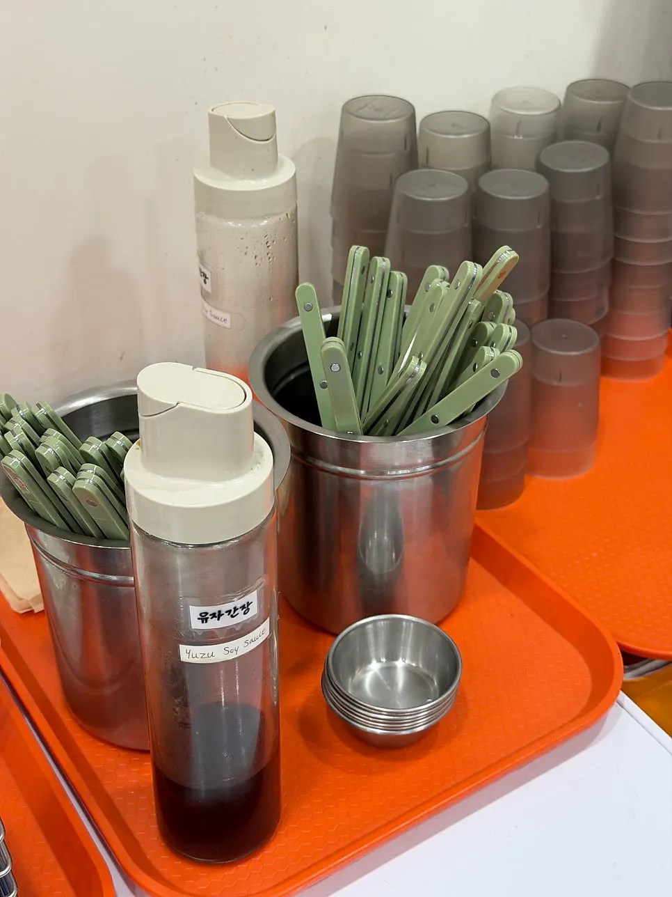 Cutlery and yuzu soy sauce set out at the self-serve bar