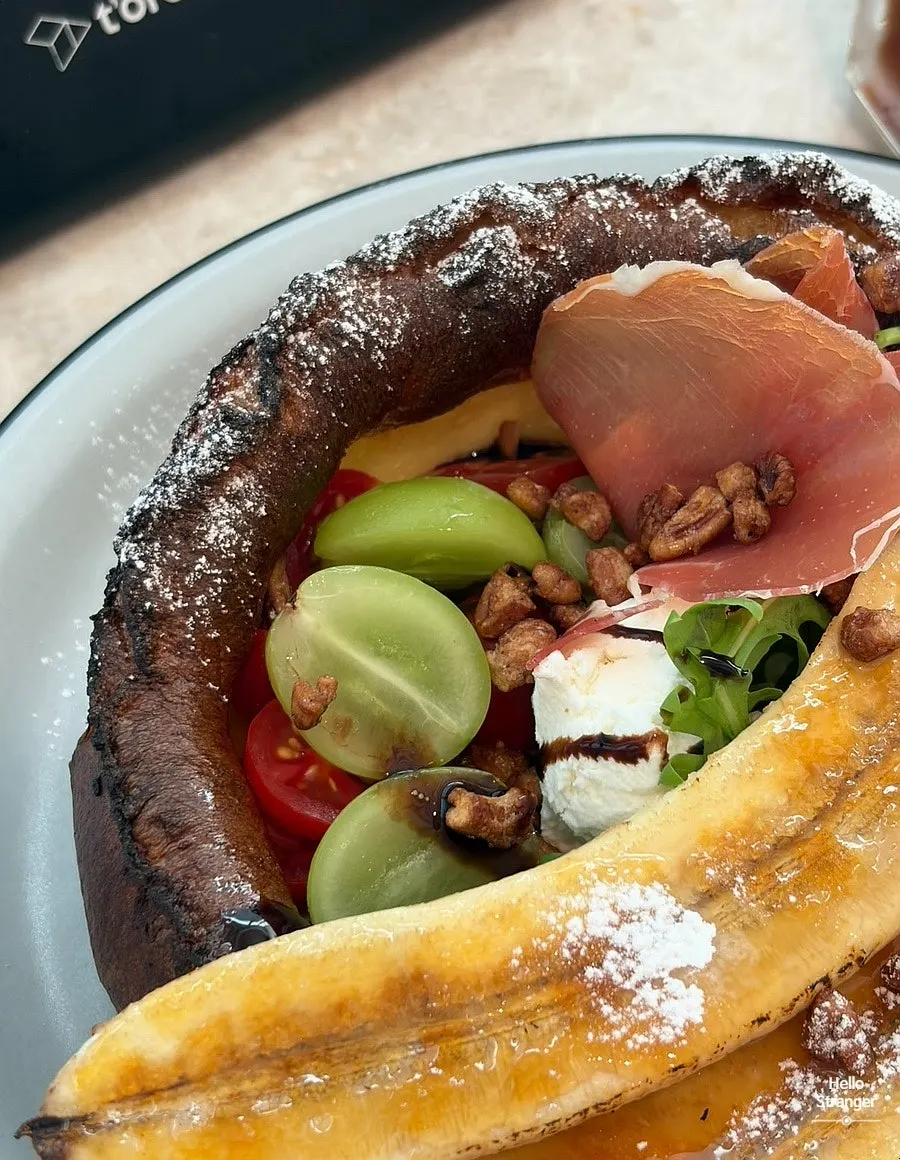 Popover pancake with fruit and prosciutto