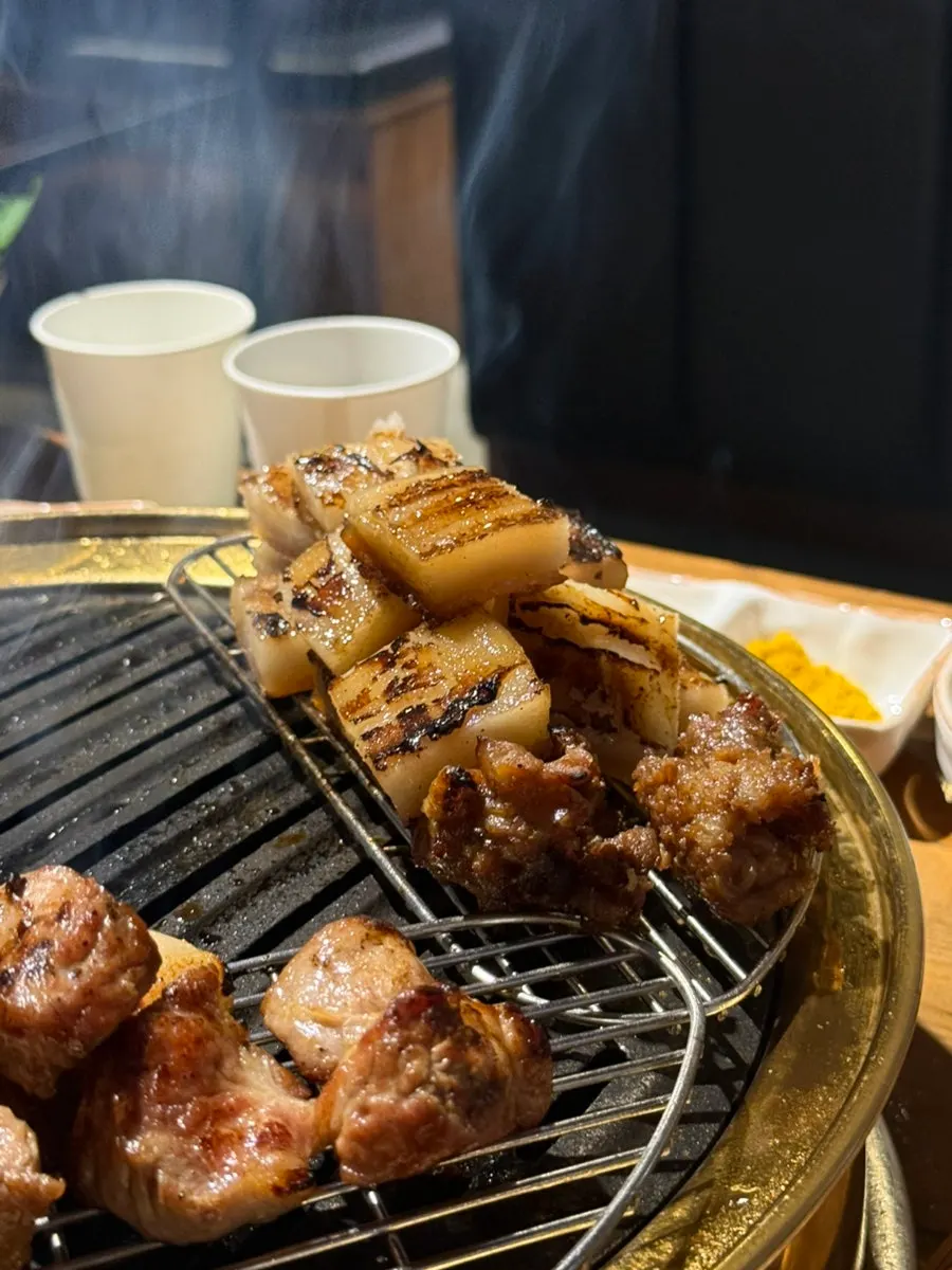 Thick pork skin cooking on the grill