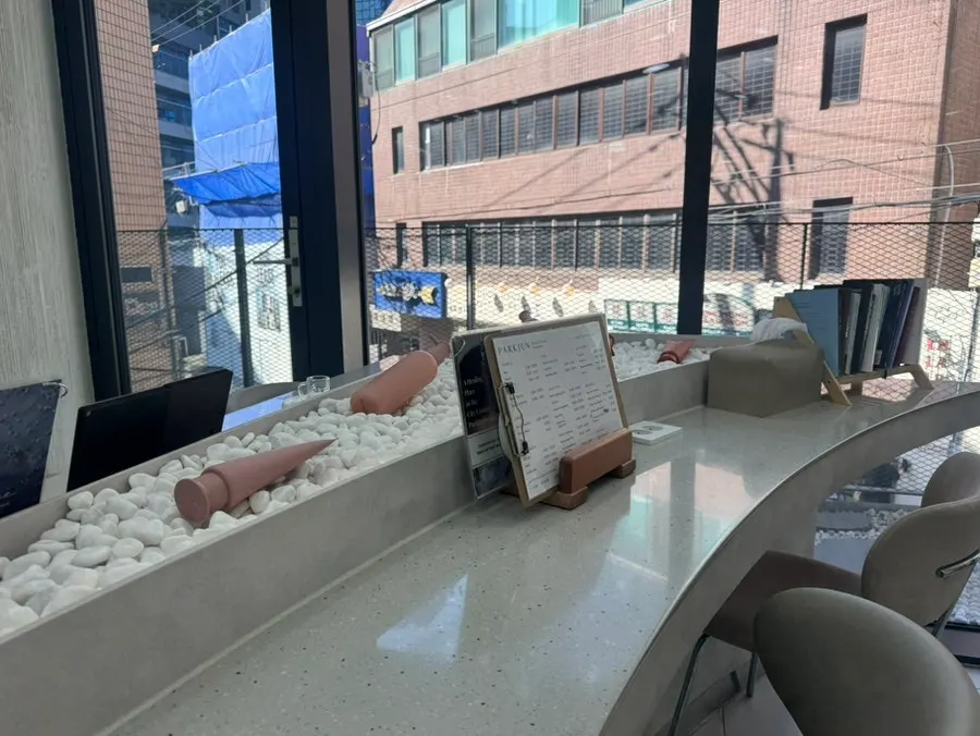 Hair salon interior filled with natural light from full windows
