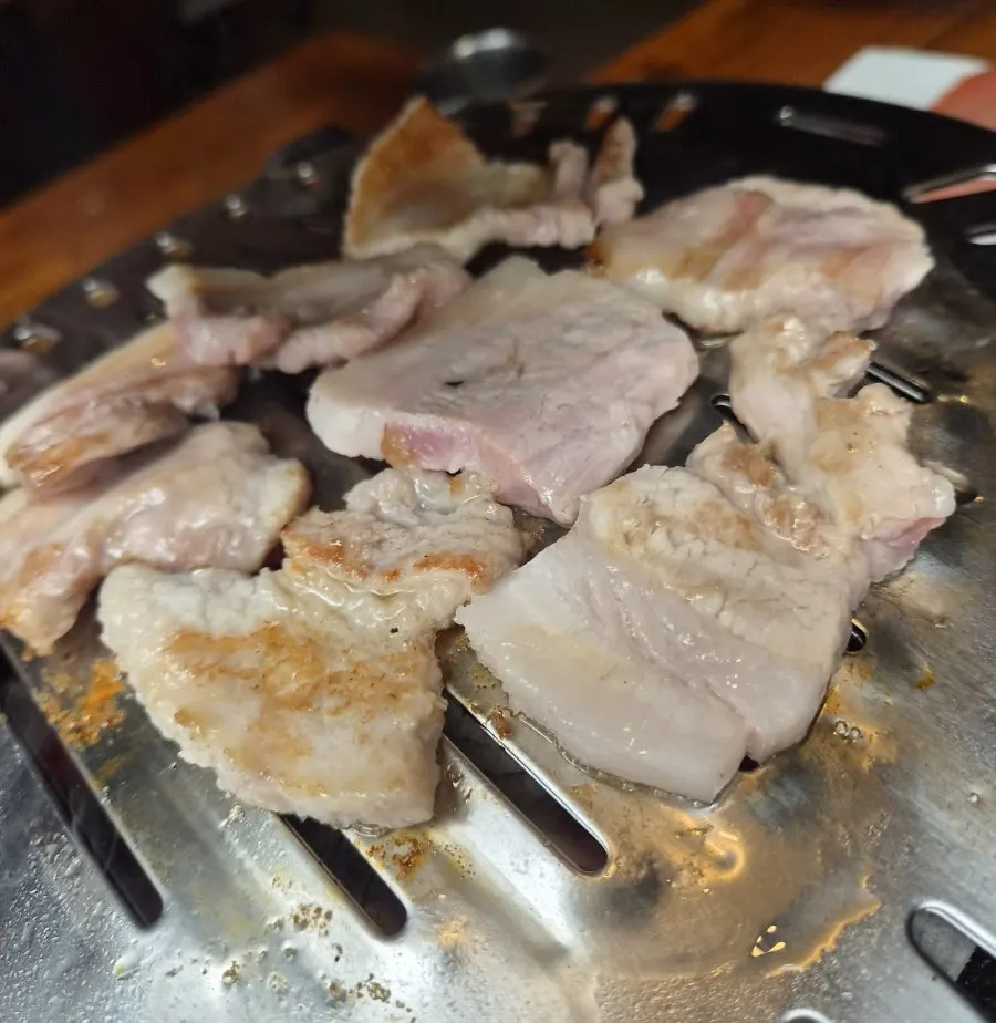 Bongu Hwarro pork belly cooking over high heat