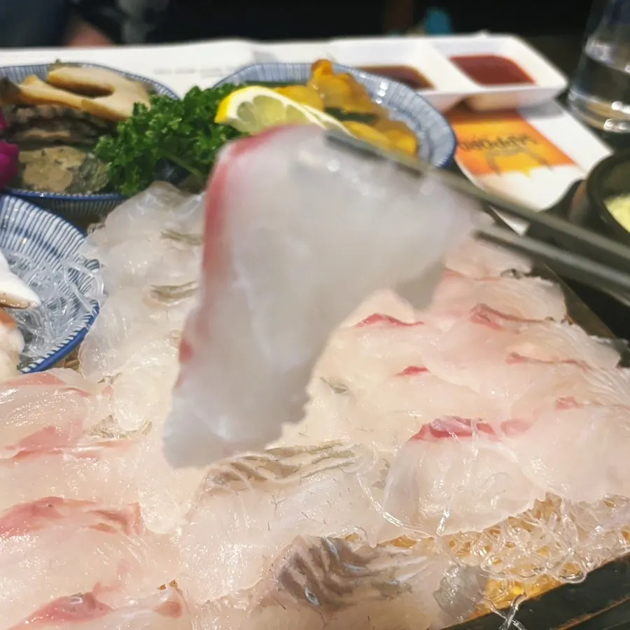 Sea bream sashimi with reddish skin visible