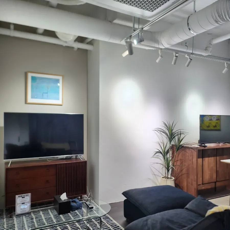 Private room equipped with a sofa, TV, and table
