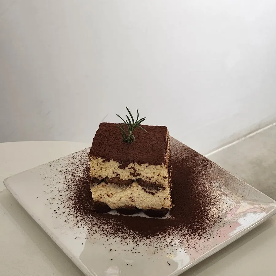 Square classic tiramisu topped with cocoa powder