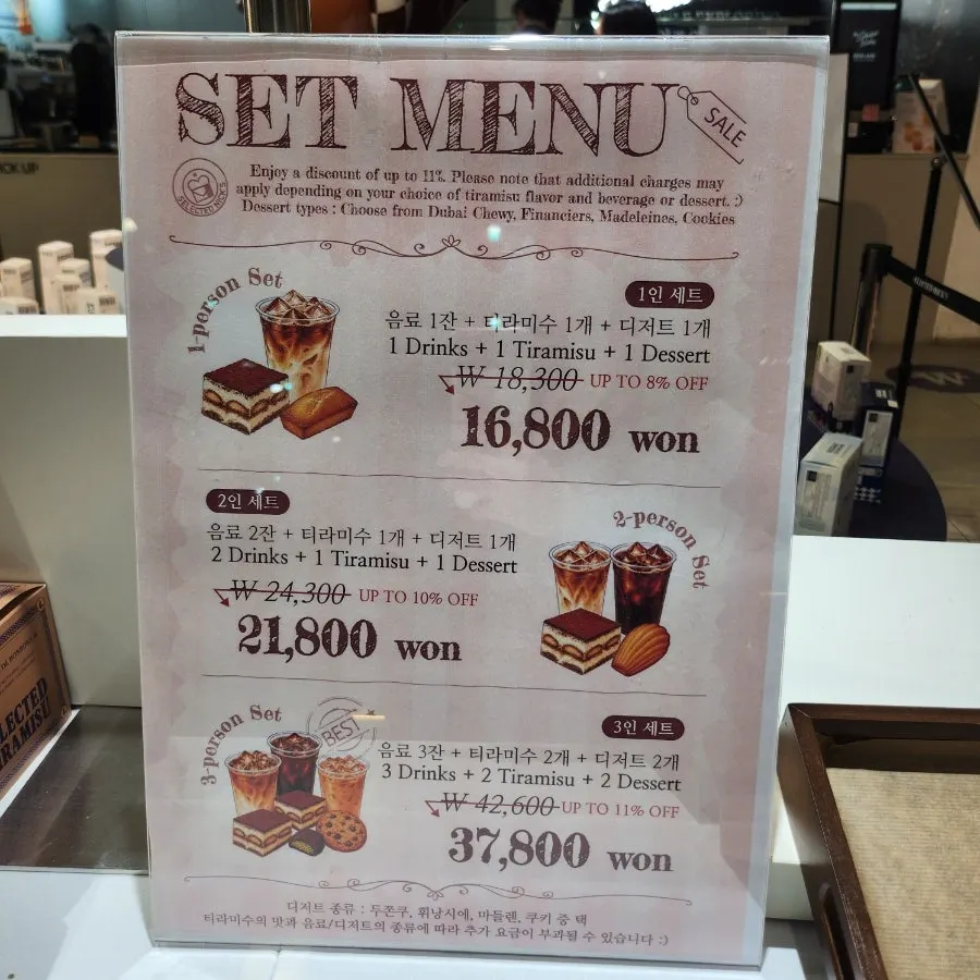 Table setting with two drinks and a classic tiramisu