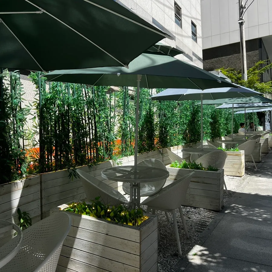 Lush green outdoor terrace seating at the café