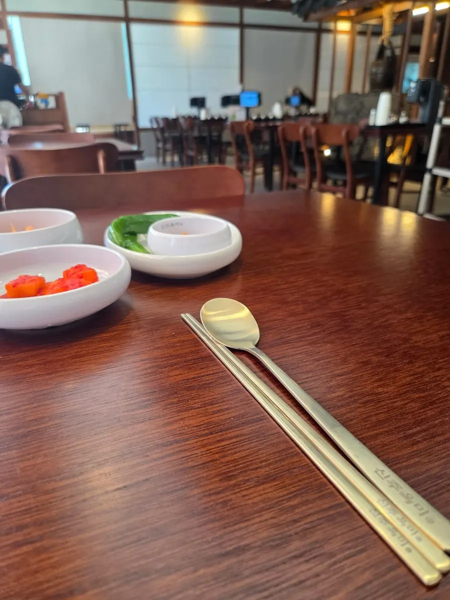 Cubed radish kimchi served alongside the soup
