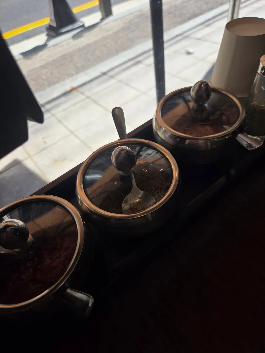 Salt and other seasoning containers on the table