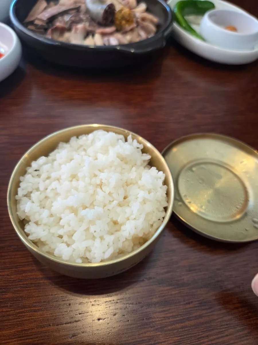 A spoonful of sundaeguk eaten with rice