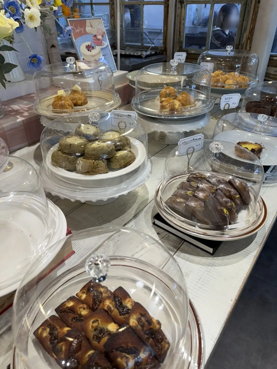 Dessert showcase with baked goods and fruit sandos