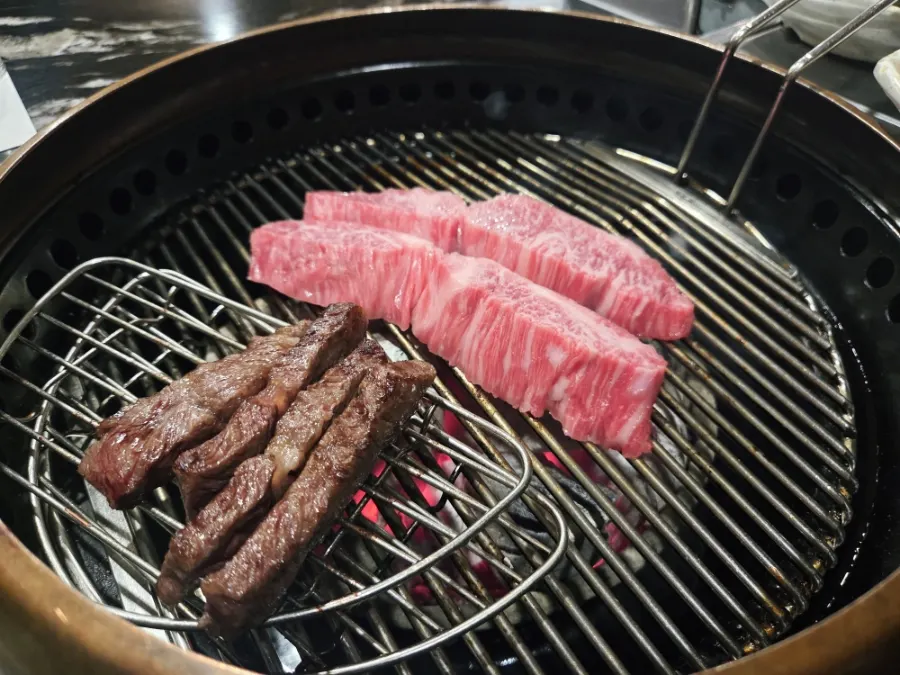 Staff grilling meat at the table