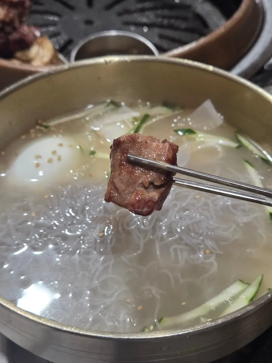 A glass of drink alongside the meal