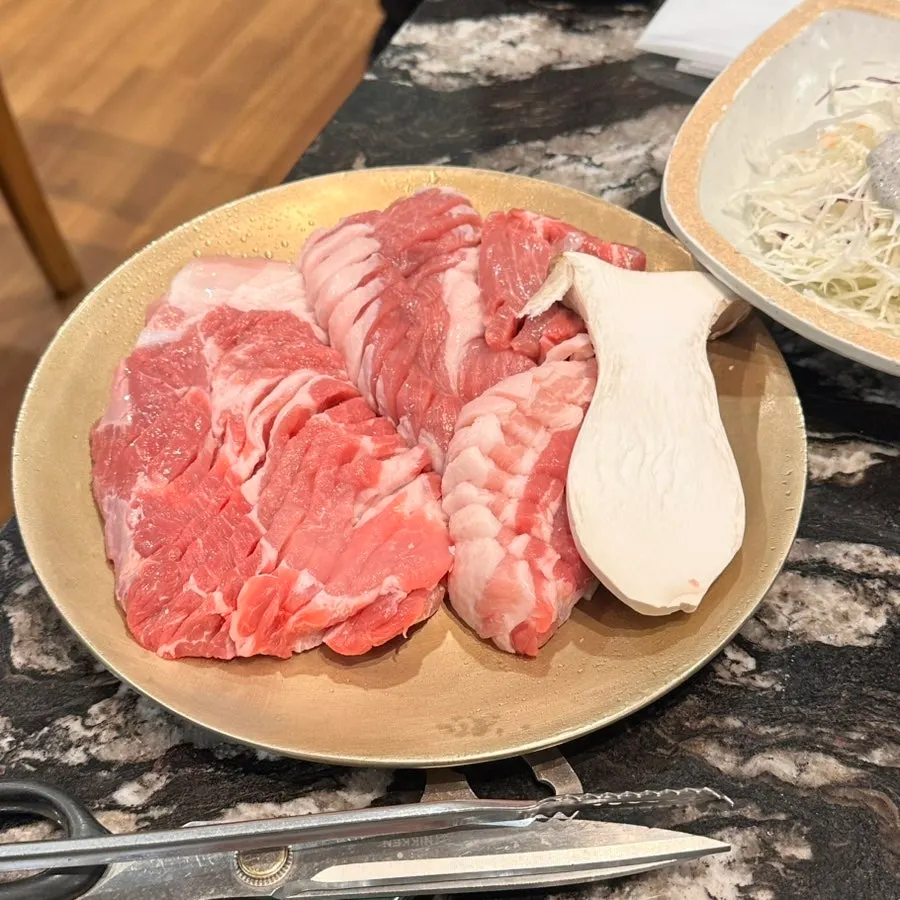 A plate of thick, knife-scored Jeju thick-cut pork