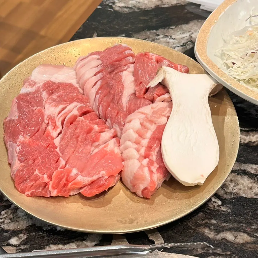 Thick Jeju pork cooking on the grill