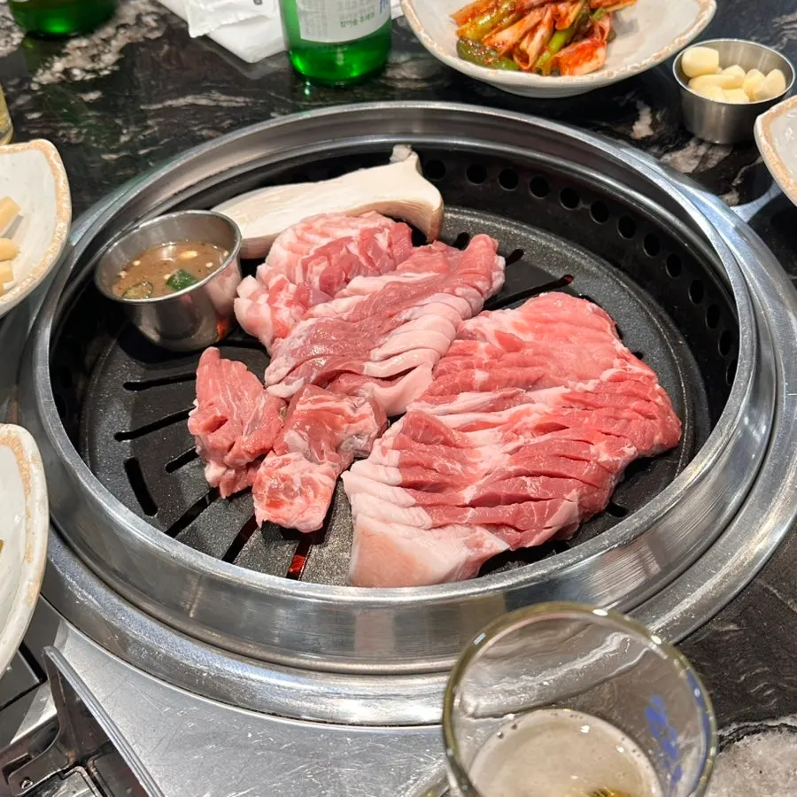 Staff flipping the meat while checking doneness