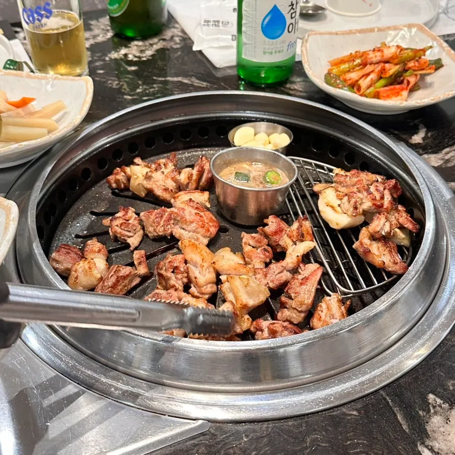 A full spread of grilled meat with side dishes