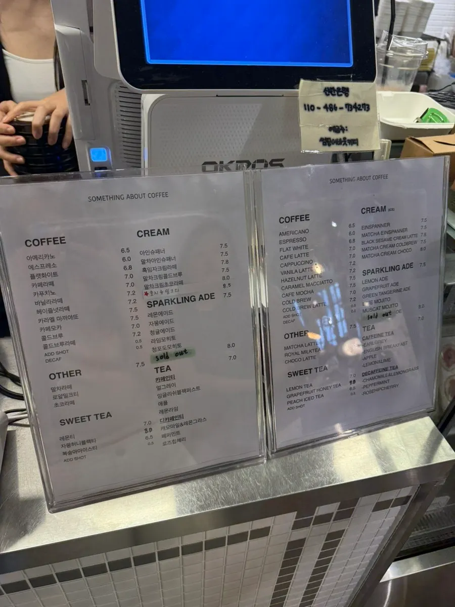 Drink menu board listing coffee, lattes, and teas