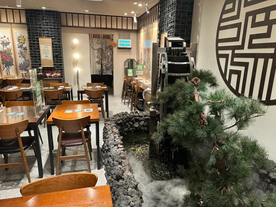 Garden area with a water wheel inside the restaurant