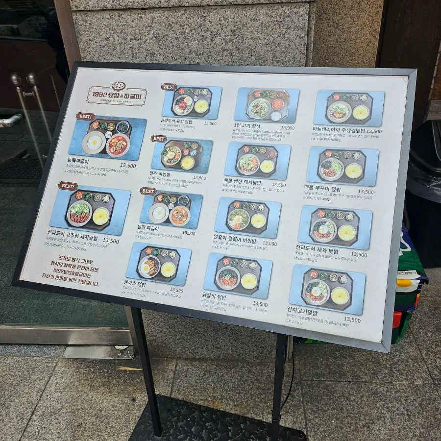 Menu board listing rice bowls, bibimbap, and stews