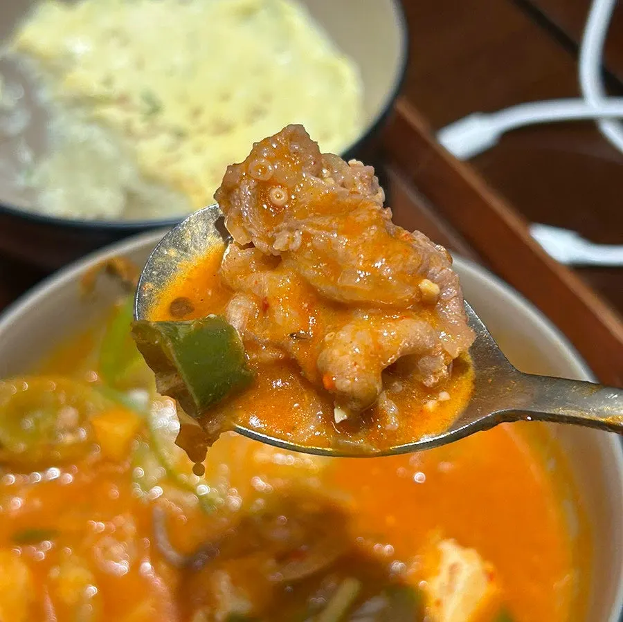 Rich broth and ingredients inside the mini doenjang jjageuli