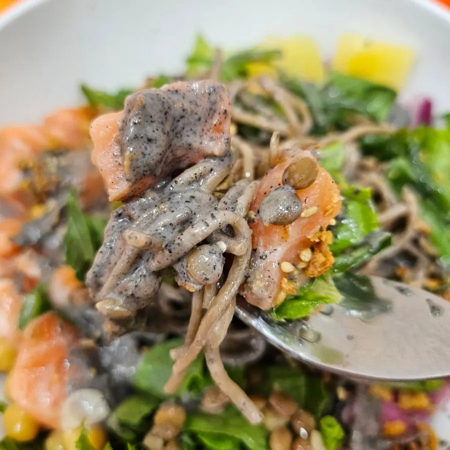 Salmon poke drizzled with black sesame sauce