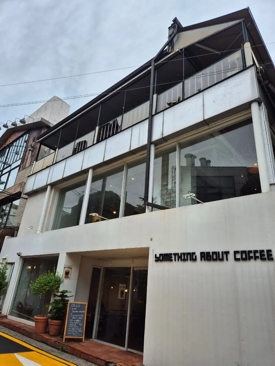 Something About Coffee's large windows and cozy café interior