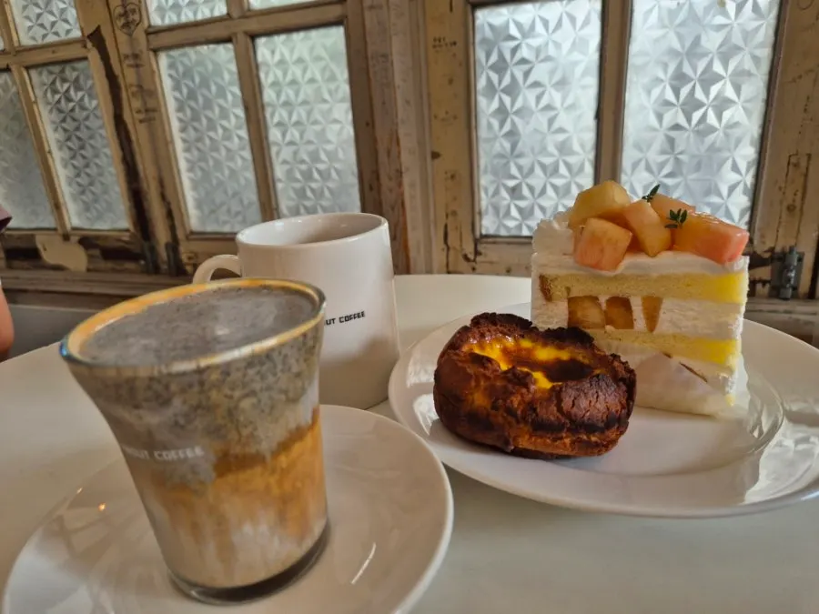 Plate with peach cream cake and egg cookie