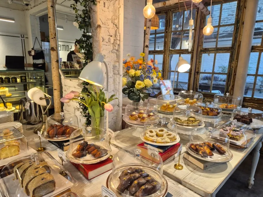 Outdoor terrace at Something About Coffee with trees and potted plants