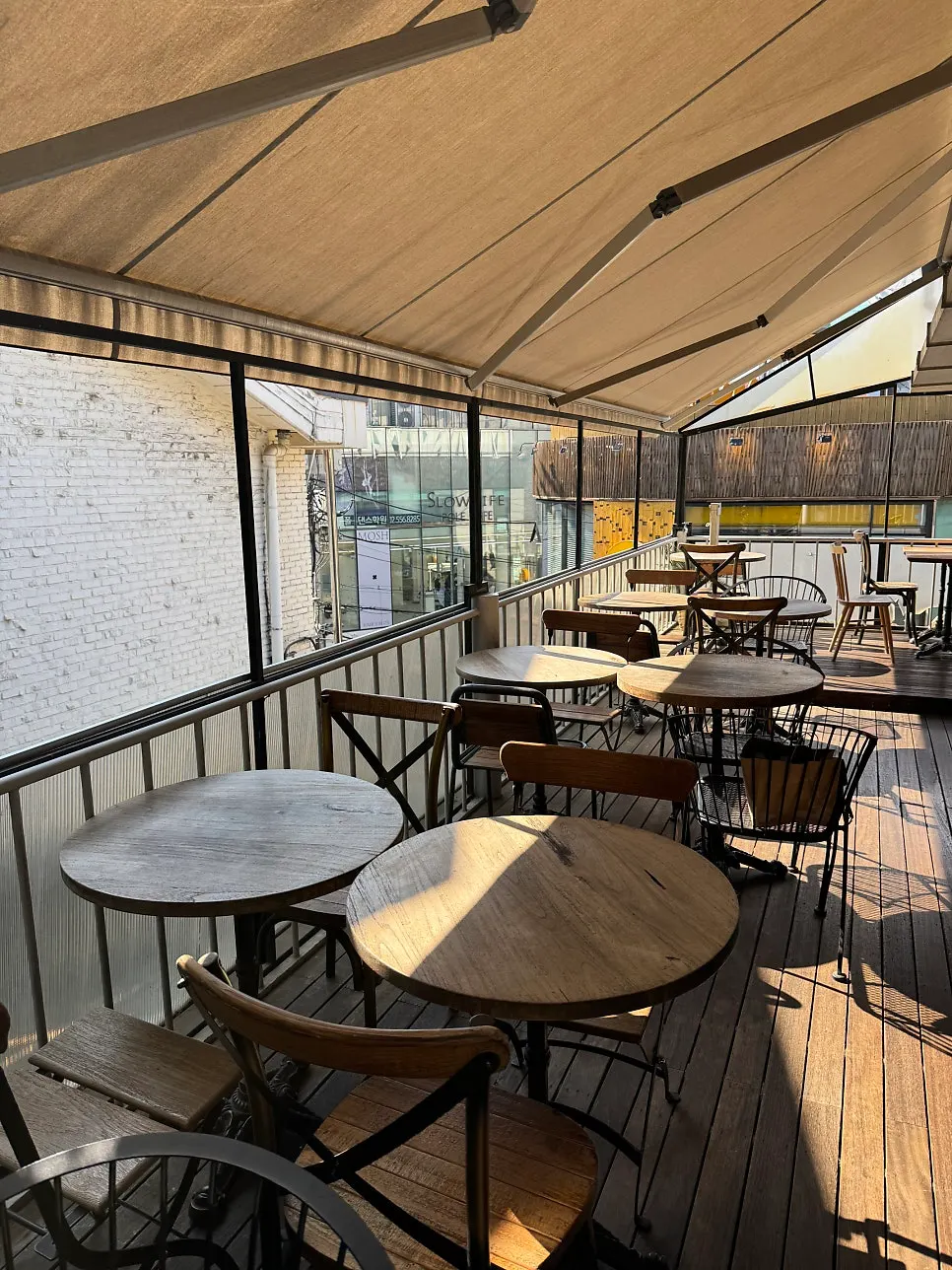 Outdoor terrace seating on the 2nd floor of Something About Coffee