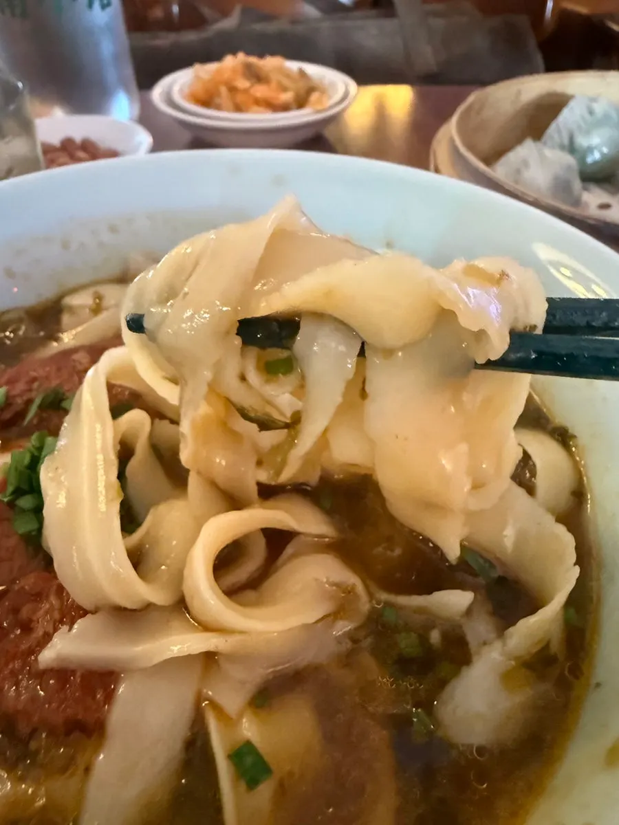 Picking up a sujeongdal dumpling with chopsticks