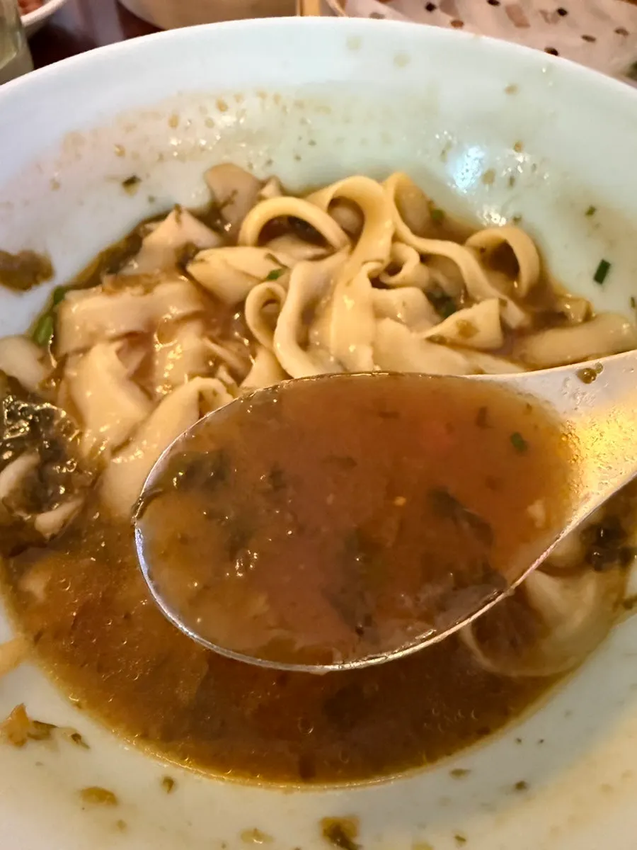 A sujeongdal dumpling cut in half showing the shrimp inside