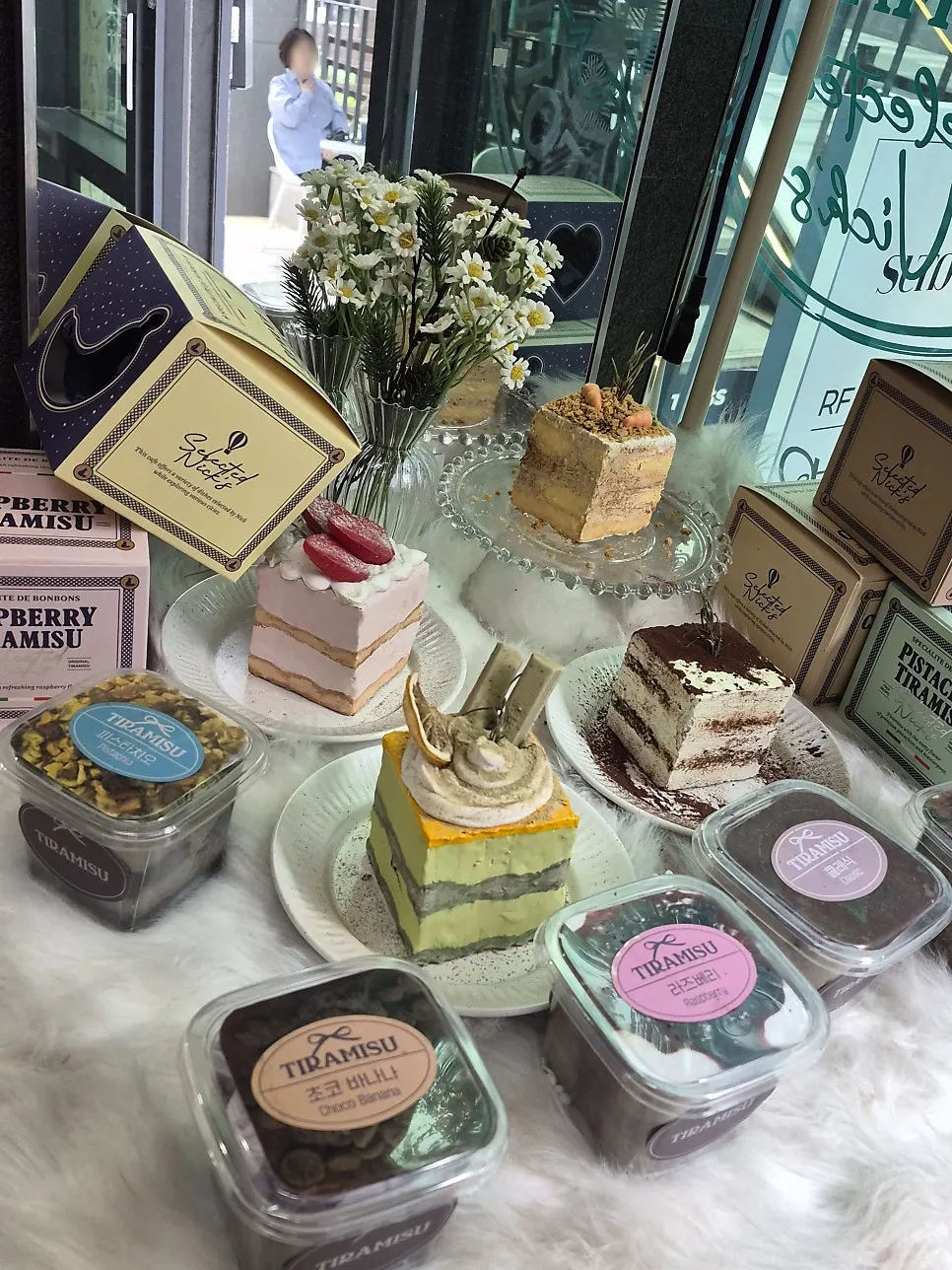 Banana, chocolate, pistachio, and other tiramisu on display