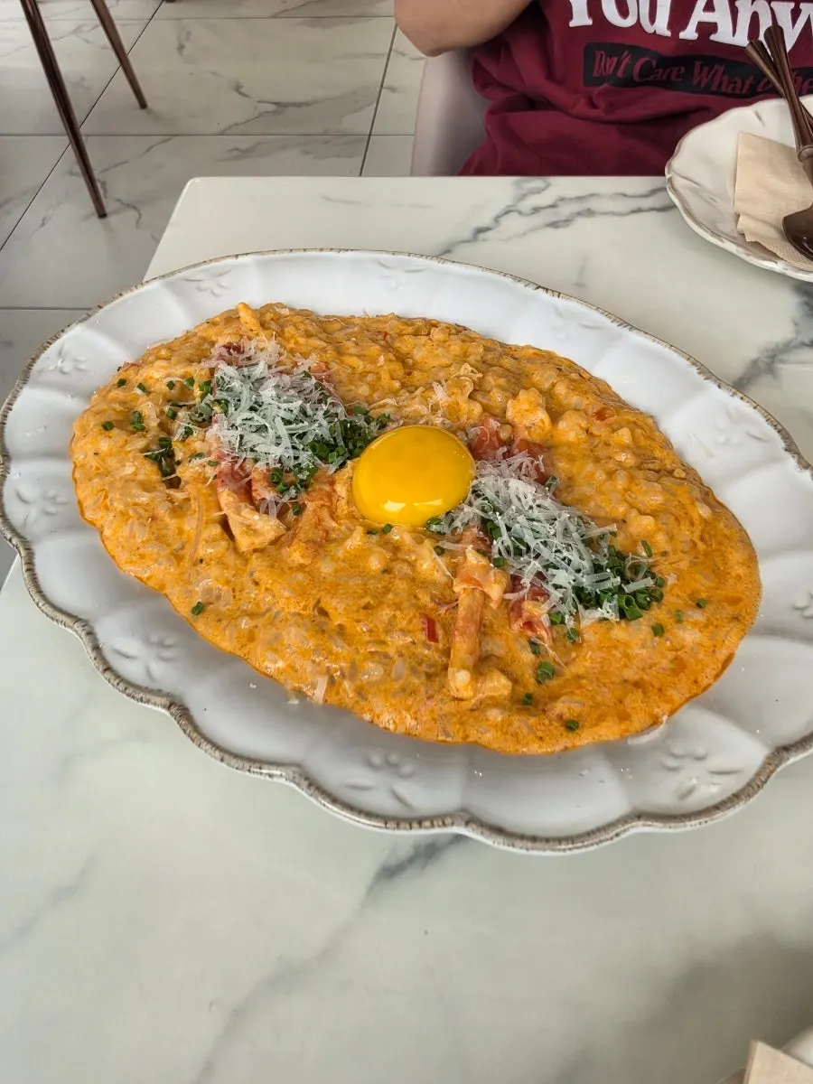 A plate of Crab Spicy Risotto topped with an egg yolk