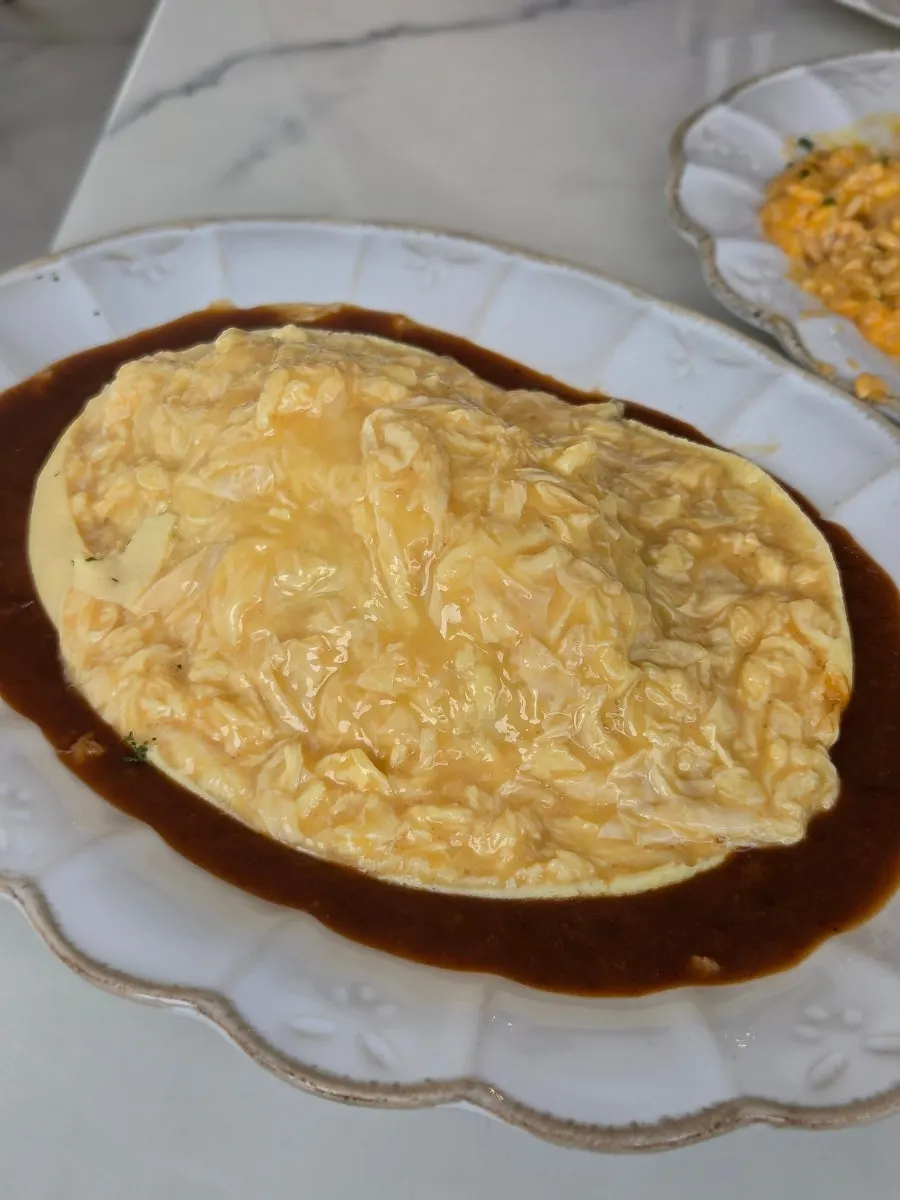 The Darak Omelet Rice's egg cut open and spread out in the center