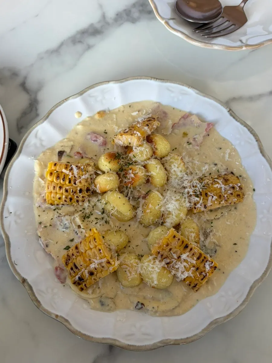 Corn gnocchi and katsu sando set on the table