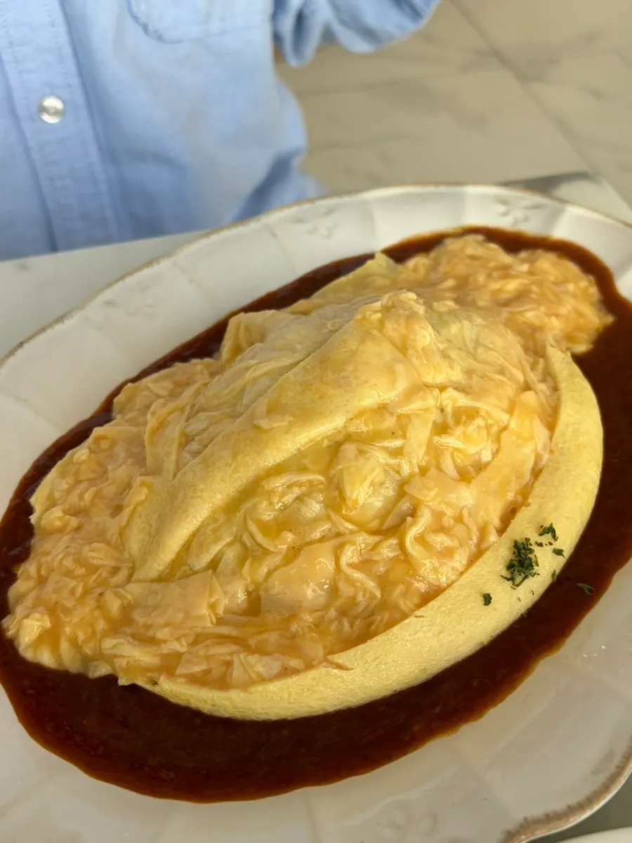 Fried rice revealed beneath the poured egg in the Darak omelet rice