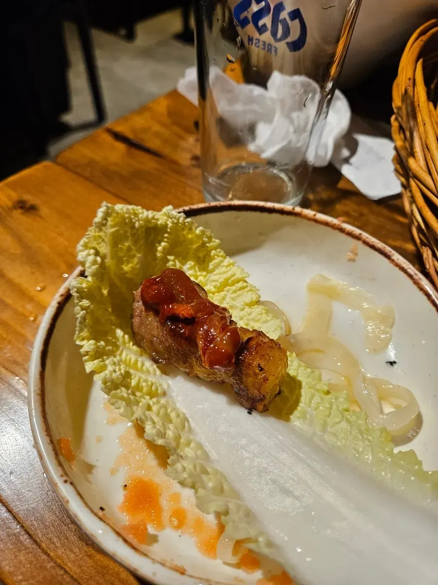 A piece of pork belly dipped in salt